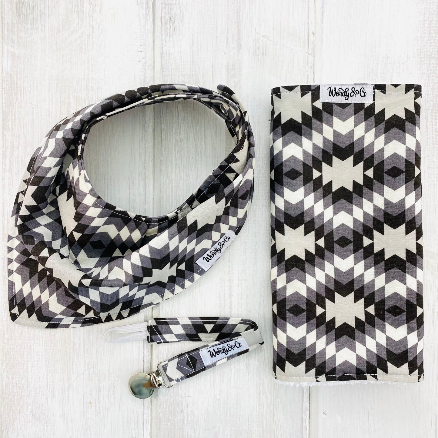 Handmade burp cloth, paci clip and bandana bib in southwest print in grays, black, white.
