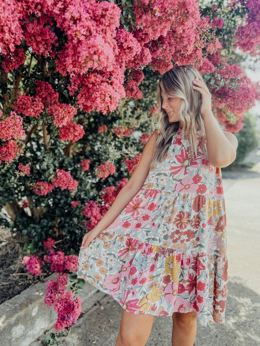 Pink multi Floral ruffle mini dress with pickets and front tie detail